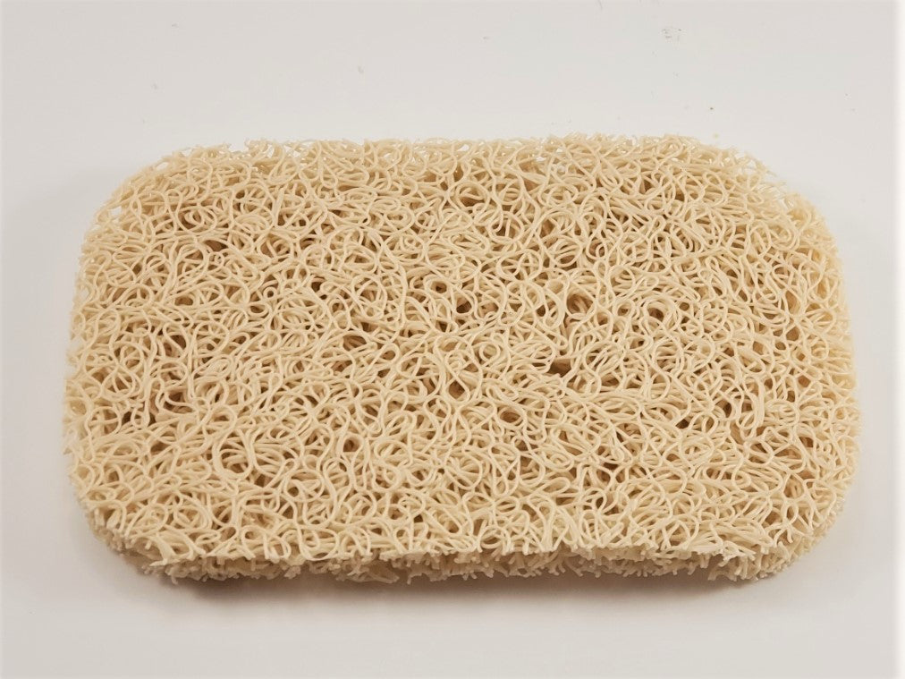 Amillia Acres' Soap Saver is a rectangular beige loofah pad featuring a rough, intertwined texture on a white background, designed to extend the life of your soap.