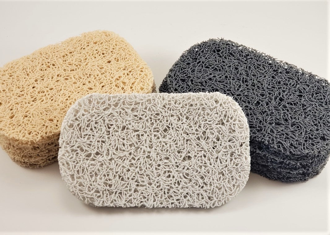 Three rectangular soap savers from Amillia Acres are presented: one in light beige, another in gray, and the last in dark gray. Each piece boasts a textured, woven surface designed to prolong the life of your soap. They are elegantly arranged on a white background.