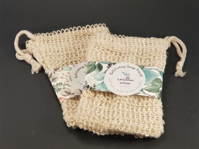 Two Exfoliating Soap Saver Bags by Amillia Acres, expertly crafted from natural sisal material. Each bag features a drawstring closure and a decorative band with floral and leaf patterns, designed to ensure gentle exfoliation for your skin.