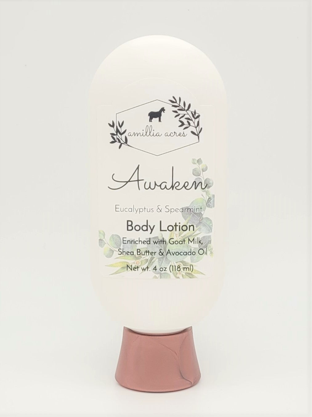 A bottle of "Awaken" Goat Milk Lotion by Amillia Acres, infused with eucalyptus and spearmint scent. Enriched with shea butter and avocado oil, this nourishing moisturizer comes in a white bottle with a beige cap, featuring botanical illustrations.