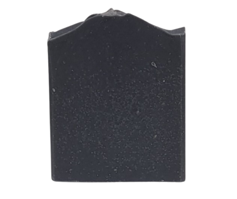 A dark gray, rectangular tombstone with an arched top, evocative of activated charcoal's deep hues, stands isolated on a white background. (Product: Balance Goat Milk Soap by Amillia Acres ~ Goat Milk Soaps and Lotions).
