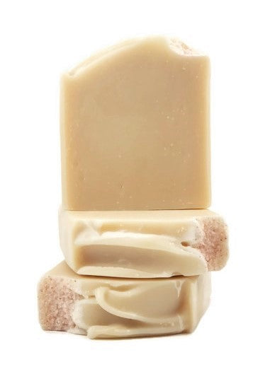 Three bars of Simplicity Goat Milk Soap from Amillia Acres are stacked; the top bar is upright and the two below are horizontal, featuring textured surfaces and rough edges. The soap looks smooth and creamy, suggesting moisturizing properties.