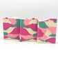 Three rectangular bars of Willow Blossom Goat Milk Soap by Amillia Acres, featuring a pink, green, and cream marbled pattern, stand upright against a white background.