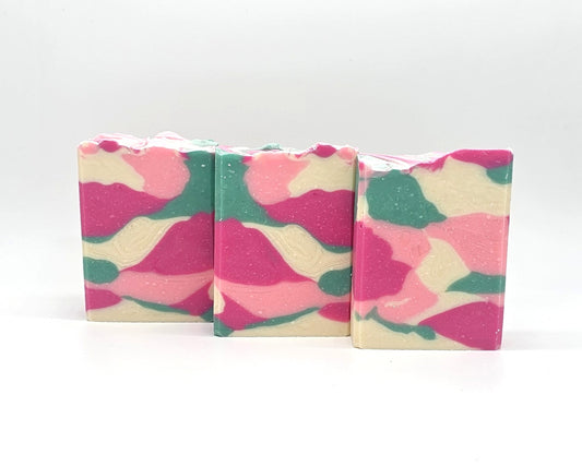 Three rectangular bars of Willow Blossom Goat Milk Soap by Amillia Acres, featuring a pink, green, and cream marbled pattern, stand upright against a white background.