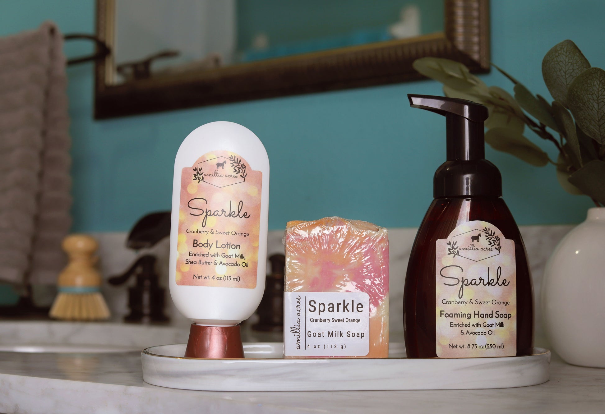 The "Sparkle" Goat Milk Lotion by Amillia Acres ~ Goat Milk Soaps and Lotions sits on a bathroom countertop, accompanied by a mirror, plant, and accessories in the background.