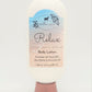 A 4.0 oz bottle of "Relax" Goat Milk Lotion by Amillia Acres blends luxury with handmade skincare, featuring coconut, jasmine, and driftwood scents. The white label with blue and beige design highlights its enriching blend of goat milk, shea butter, and avocado oil.